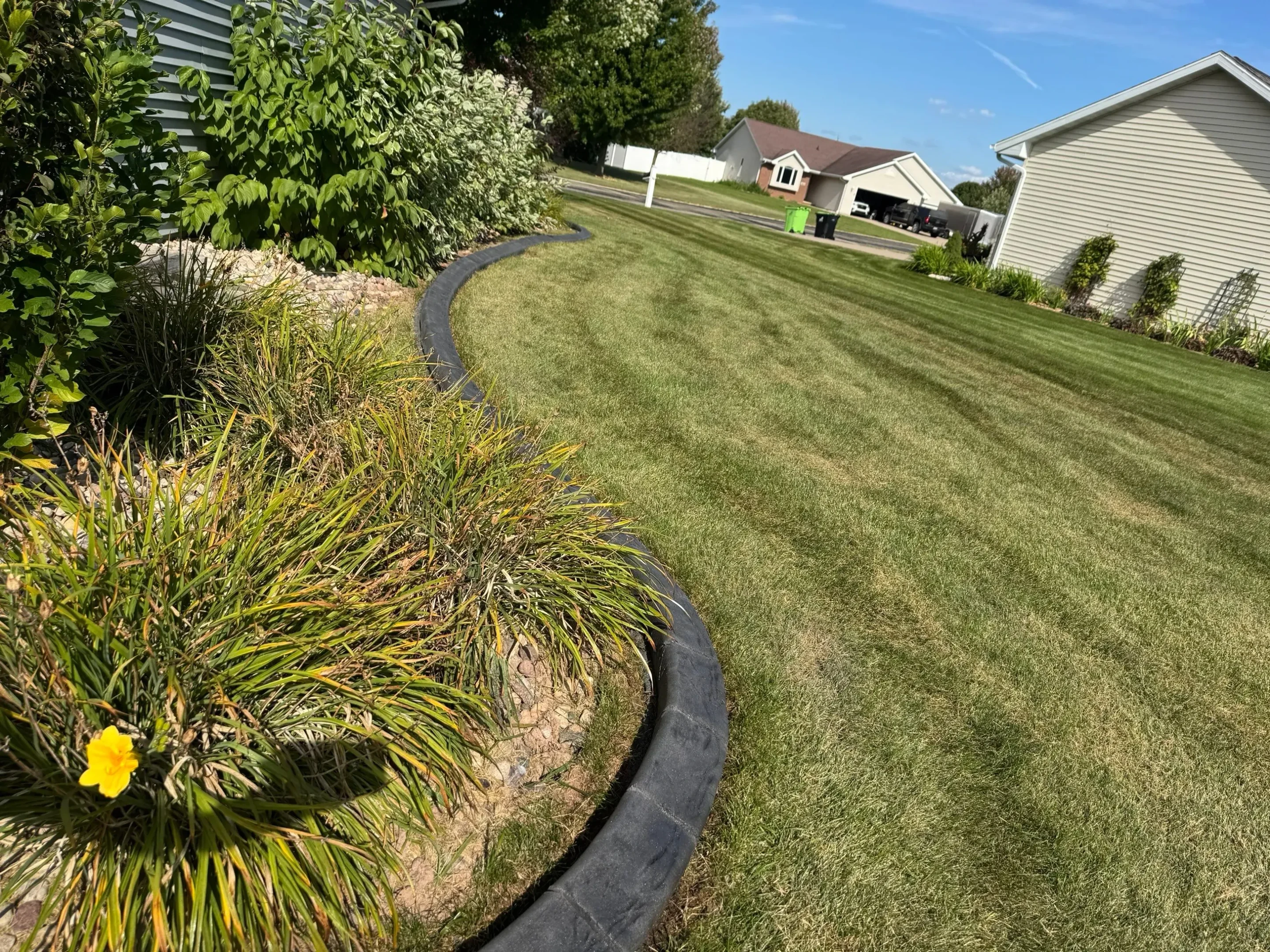 Curved mower curbing around landscape feature
